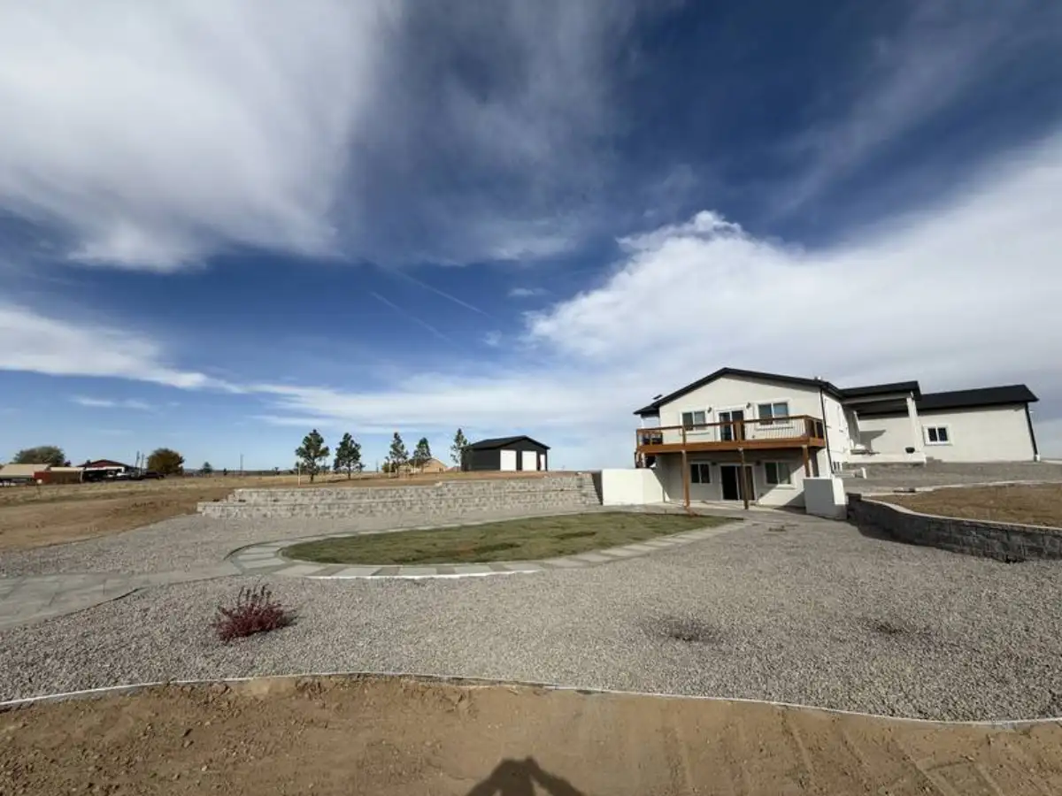 Outdoor living area with fire pit, paver patio, and rock landscaping in Colorado Springs