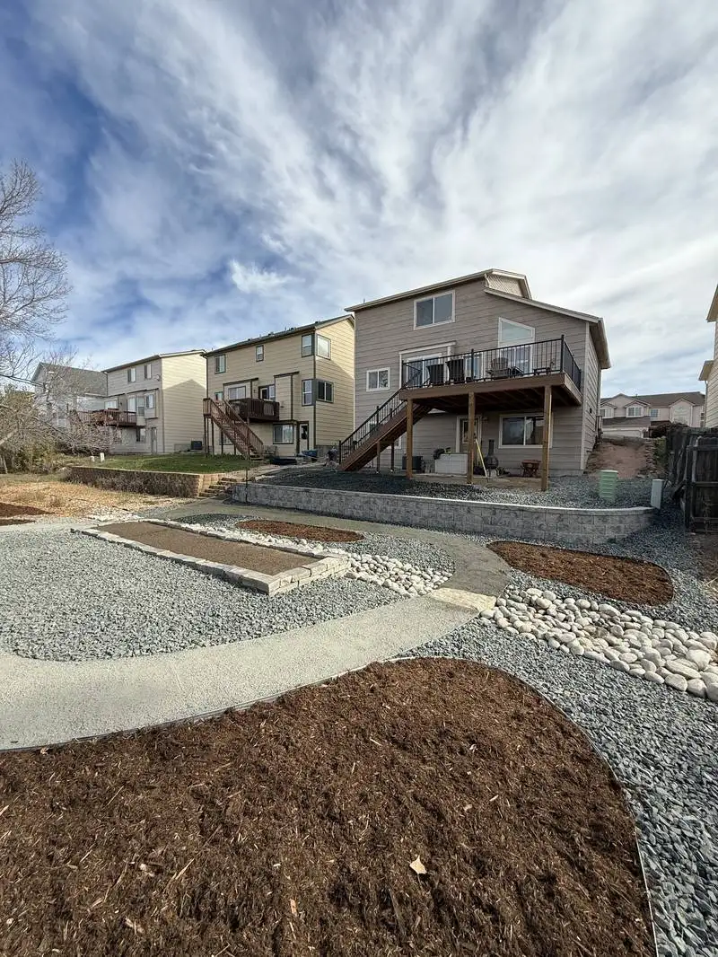 Custom fire pit area with gravel and retaining wall built by CN Landscaping in Colorado Springs