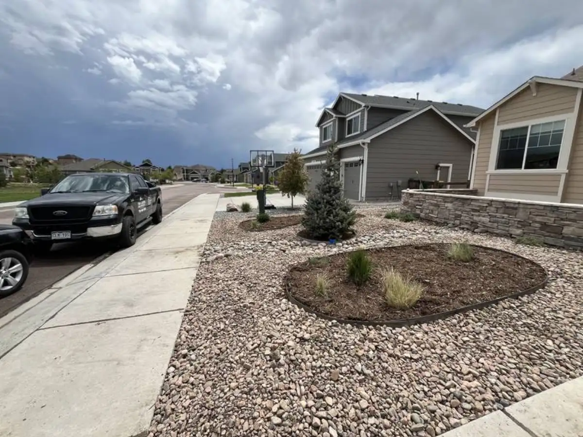Rock landscaping with drainage integration on a Colorado Springs hillside